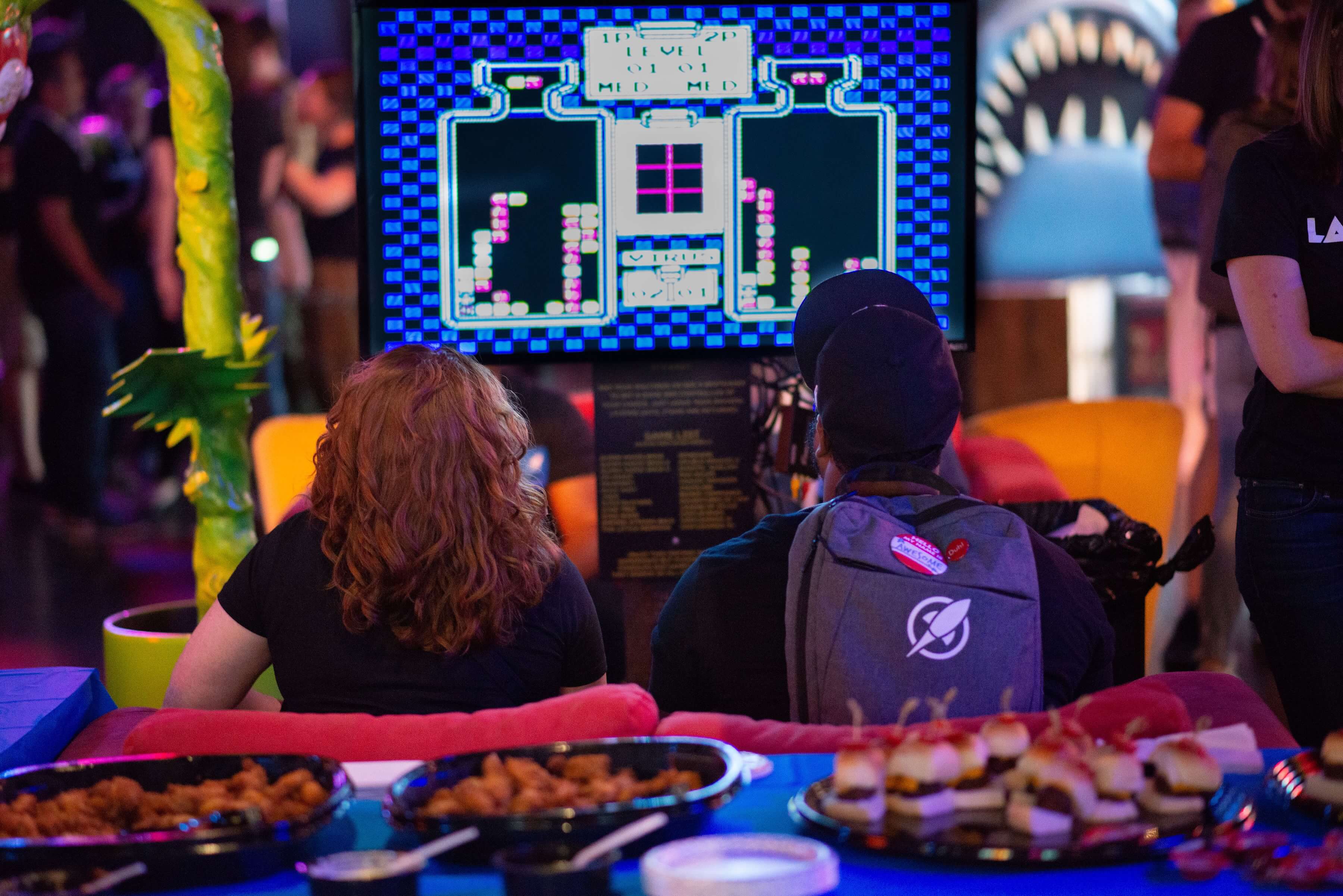 Team members at a retro arcade event