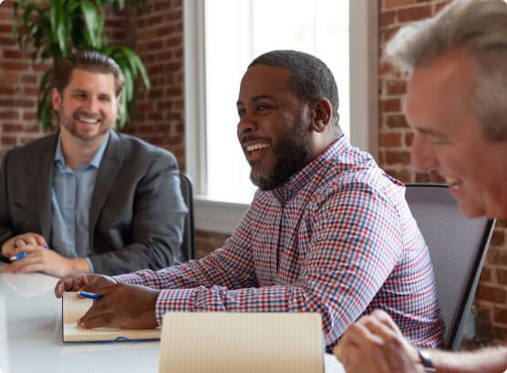 Launch That team smiling during a meeting