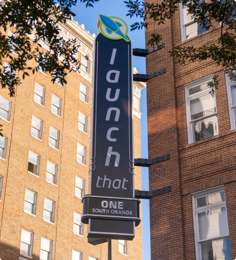 Launch That Orange Ave building sign