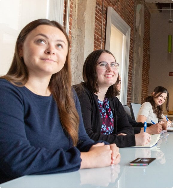 Launch That team taking notes in a meeting